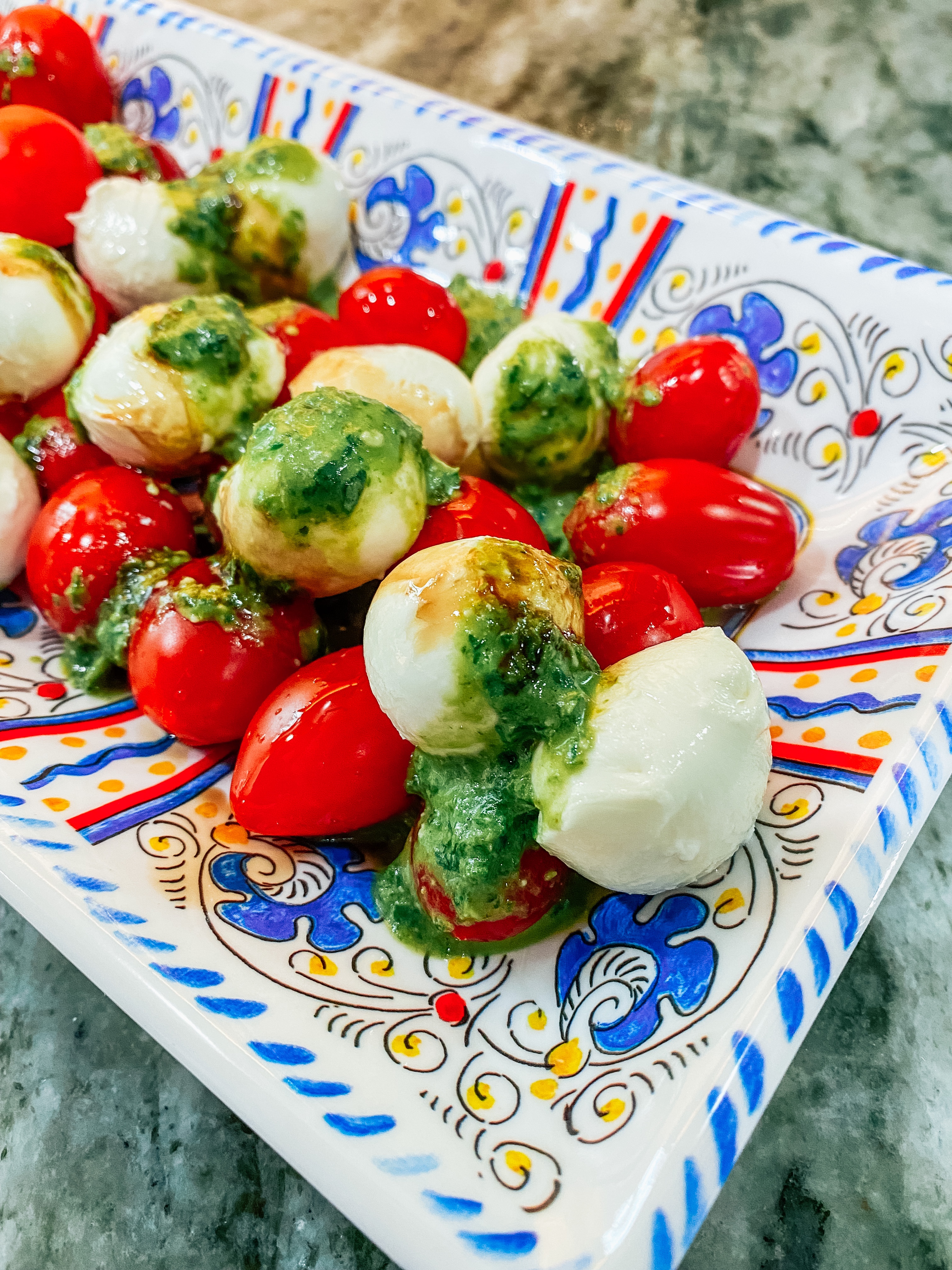 Bite sized caprese salad with basil pesto